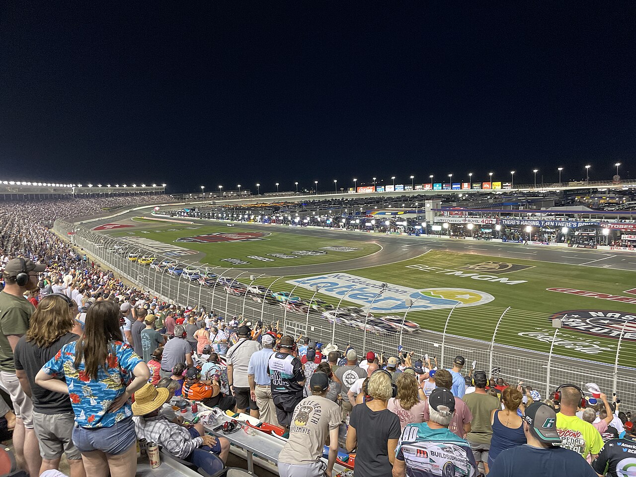 Charlotte Motor Speedway — The 2024 Coca-Cola 600 at Charlotte Motor Speedway viewed from the frontstretch. Christopher Bell (#20) leads the field at the beginning of 